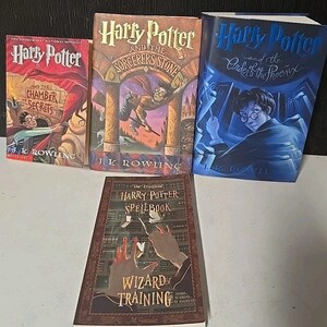 May include: Four books including Harry Potter and the Chamber of Secrets, Harry Potter and the Sorcerer's Stone, Harry Potter and the Order of the Phoenix, and The Unofficial Harry Potter Spellbook Wizard Training by M. Gonzalez with illustrated covers.