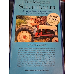 May include: A book cover titled "The Magic of Scrub Holler" with a photo of a farmer on a red and white tractor. The cover is light blue with the text "Ozarks Stories" in a circle. The author is Lanny Gibson.