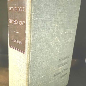 May include: A hardcover book titled Pathologic Physiology by Sodeman with a light green textured fabric cover. The spine features a dark brown rectangular panel with white text reading Pathologic Physiology and Sodeman, framed by thin horizontal lines.