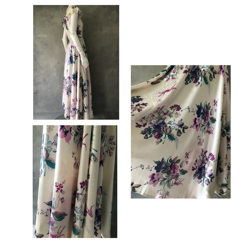 May include: A long white dress with a floral print in shades of purple and green. The dress has a fitted bodice and a flowing skirt.