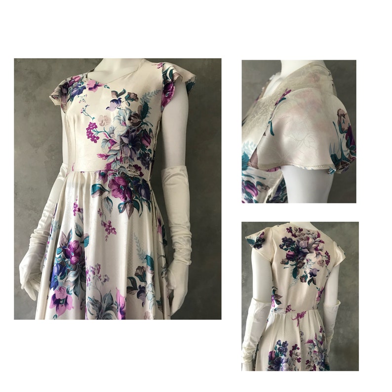 May include: A white satin dress with a floral print in shades of purple, teal, and pink. The dress has a V-neckline, short sleeves, and a full skirt. It is shown with white gloves.