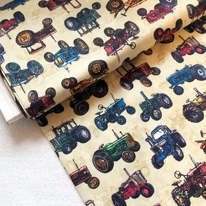 Könnte beinhalten: Ein beigefarbener Stoff mit einem sich wiederholenden Muster aus Vintage-Traktoren in verschiedenen Farben, darunter Rot, Blau, Grün und Gelb. Die Traktoren sind im Cartoon-Stil mit detaillierten Merkmalen dargestellt.