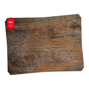 May include: A set of four brown wooden placemats with a rustic wood grain texture. The placemats are rectangular and have rounded corners. The label on the placemat reads "4er Set".
