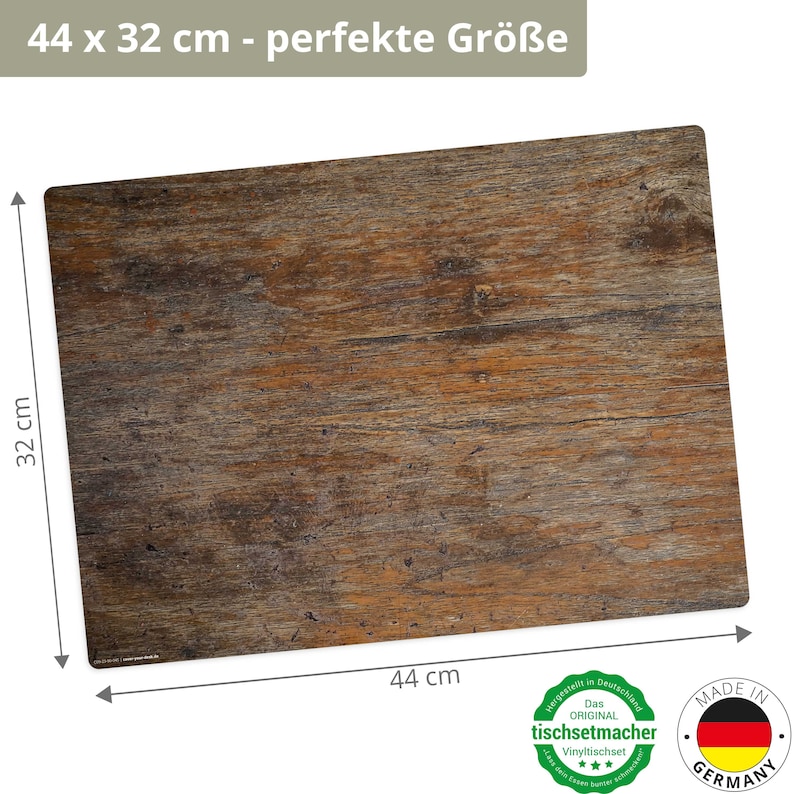 May include: A brown wood-look vinyl table mat measuring 44 cm by 32 cm. The mat has a rustic wood grain pattern. The text "44 x 32 cm - perfekte Gr&ouml;&szlig;e" is printed on the top of the image.