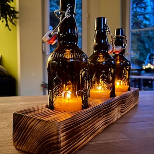 Three-flame table candlestick with Altenmünster swing-top bottles - glass on wood - special unique piece on squared wood - commissioned work