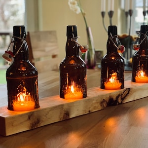 Table candlestick with old beer bottles - glass on wood - special unique piece on roof battens or squared timber - commissioned work