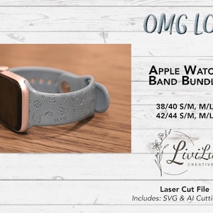 A light blue silicone watch band with various engraved words like "OMG," "LOL," "KISS," and "LOVE" is attached to a dark gray smartwatch on a wooden surface.