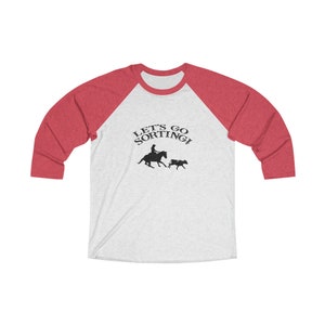 May include: A white and red baseball tee shirt with the text "Let's Go Sorting!" and a silhouette of a cowgirl riding a horse and herding a cow.