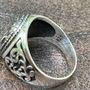 Puede incluir: Un anillo de plata con dise&ntilde;os intrincados y el n&uacute;mero "925" estampado en la banda interior.