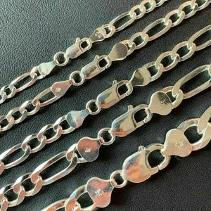 May include: Five silver chains with different lengths and widths. The chains are made of sterling silver and have a polished finish. The chains are all closed with a lobster clasp.