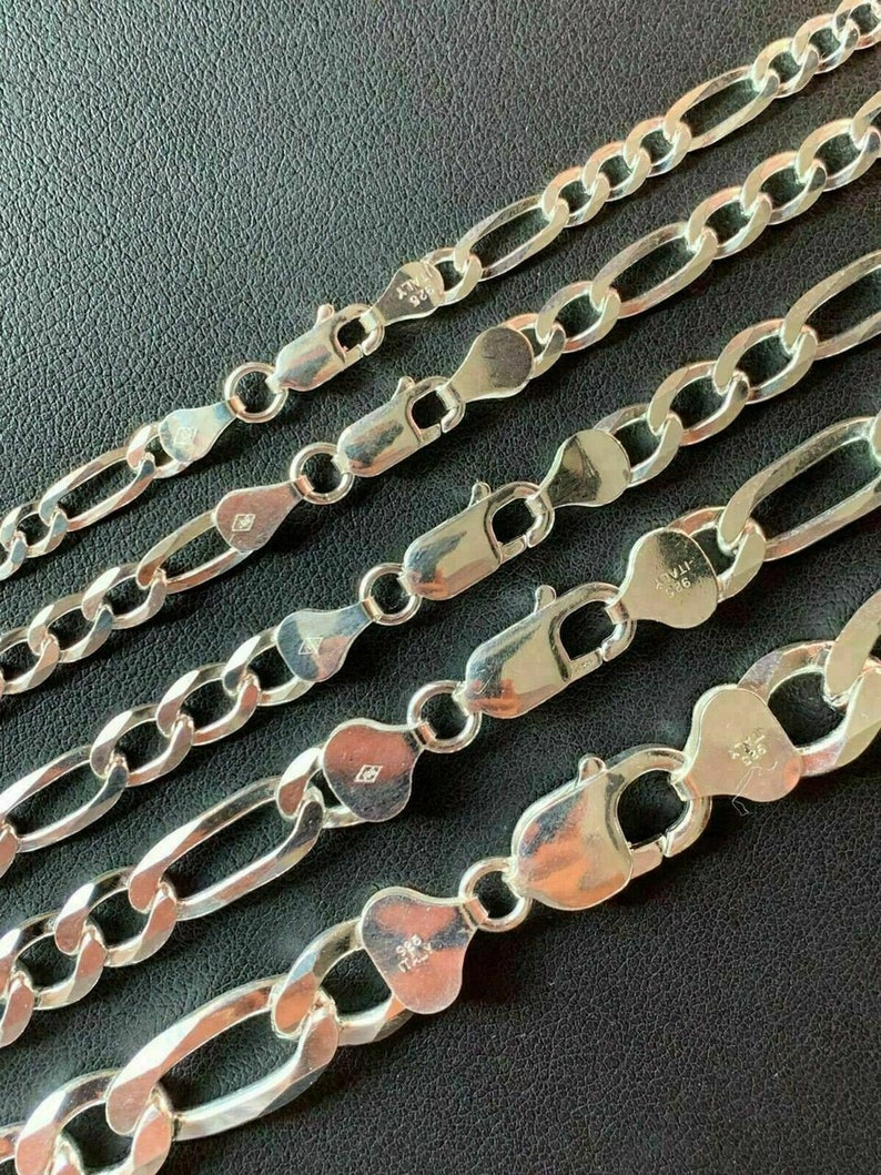 May include: Five silver chains with different lengths and widths. The chains are made of sterling silver and have a polished finish. The chains are all closed with a lobster clasp.
