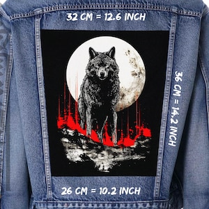 May include: A black and white wolf howling at the moon, with red streaks of color in the background. The image is on a denim jacket with measurements in inches.