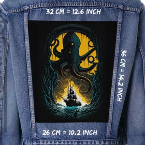 May include: A black denim jacket with a large patch on the back. The patch features a dark green and yellow illustration of a giant octopus with tentacles reaching out of the water towards a ship. The text "32 CM = 12.6 INCH", "36 CM = 14.2 INCH", and "26 CM = 10.2 INCH" is printed on the jacket.