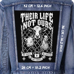 May include: A denim jacket with a large black patch featuring a cow, pig, and chicken behind a chain-link fence. The patch includes the text "THEIR LIFE NOT OURS," and measures 12.6 inches wide by 14.2 inches high.