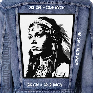May include: Black and white illustration of a Native American woman wearing a headdress and a necklace. The image is on a denim jacket with measurements in inches and centimeters.
