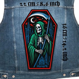 May include: A denim vest with a large patch featuring a Grim Reaper design. The patch, approximately 22 cm by 36 cm, depicts the Grim Reaper with a scythe, set against a gothic church backdrop. The patch is outlined in red, with a crescent moon.