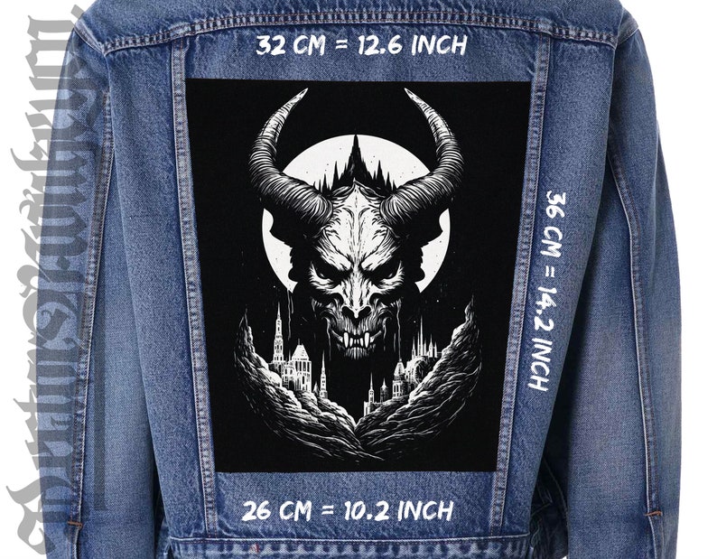 May include: A black and white denim jacket with a large patch on the back. The patch features a black and white illustration of a demon with horns and fangs, a full moon, and a castle in the background. The text "32 CM = 12.6 INCH", "36 CM = 14.2 INCH", and "26 CM = 10.2 INCH" is printed on the jacket.