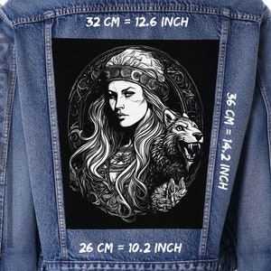 May include: Black and white illustration of a woman with long hair and a wolf. The woman is wearing a crown and a necklace. The image is on a black background and is surrounded by a decorative border. The image is 12.6 inches wide, 14.2 inches tall, and 10.2 inches deep.