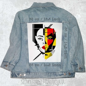 May include: A denim jacket with a colourful abstract art patch on the back. The patch features a stylised face with black, white, red, and yellow colours. The patch is 36 cm tall and 26 cm wide.