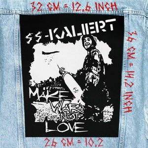 May include: A black patch featuring the text "SS-KALIERT" and a graphic of a person with a missile, with the words "MAKE WAR NOT LOVE". The patch is 32 cm wide and 36 cm tall.