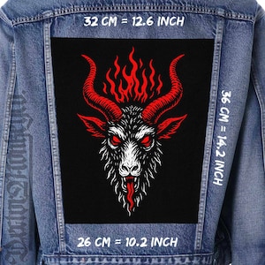 May include: A denim jacket with a large, rectangular patch featuring a goat head with red horns and flames. The patch is black with white and red details. The patch measures 32 cm by 36 cm and 26 cm.