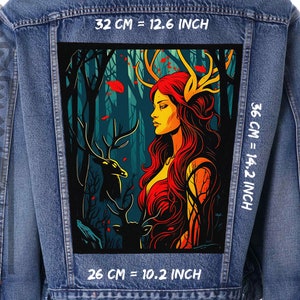 May include: A denim jacket with a large patch depicting a woman with red hair and golden antlers in a forest. The patch is 32 cm wide and 36 cm high. The artwork includes a deer and the text "32 cm = 12.6 inch" and "36 cm = 14.2 inch".