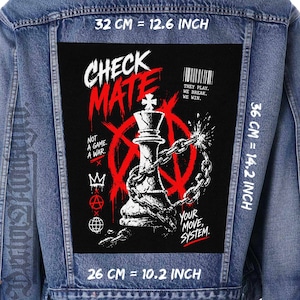 May include: A denim jacket with a large black patch featuring a chess piece, chains, and the words "CHECK MATE" in red and white. The patch measures 32 cm by 36 cm and includes the text "NOT A GAME. A WAR." and "YOUR MOVE, SYSTEM."