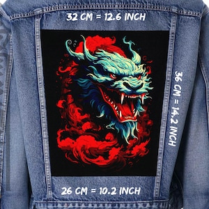 Pode incluir: Uma jaqueta de ganga com um remendo preto que apresenta um dragão azul e vermelho com uma expressão feroz. O remendo mede 26 cm de largura, 32 cm de altura e 36 cm de comprimento.