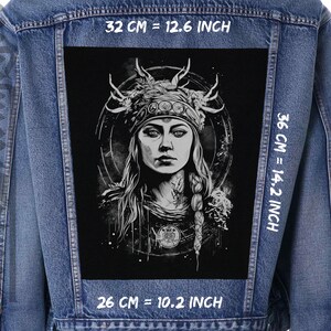 May include: A black and white illustration of a woman with a crown of antlers and a third eye. The image is on a black background and is 10.2 inches wide, 12.6 inches tall, and 14.2 inches long.