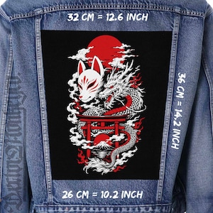 May include: A blue denim jacket featuring a large rectangular patch on the back. The patch displays a white fox mask, a dragon, a red torii gate, and a mountain under a red sun. Text indicates dimensions of 32 cm by 36 cm and 26 cm by 12.6 inches.