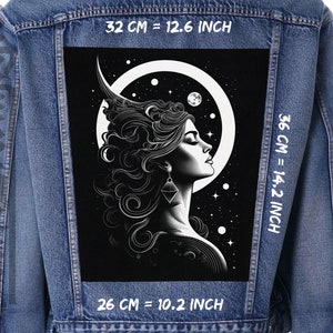 Op de afbeelding: Een zwart-witte illustratie van een vrouwengezicht met lang haar, omringd door een halve maan en sterren. De afbeelding is gedrukt op een zwarte stoffen patch, die 32 cm breed, 36 cm hoog en 26 cm diep is.