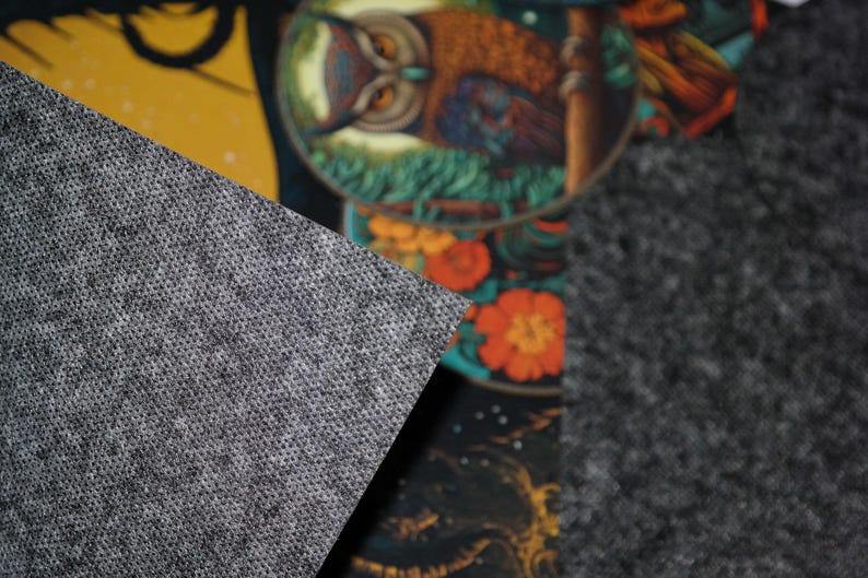 May include: Close-up of a gray textured fabric with a subtle pattern. The fabric is a popular choice for upholstery and crafts.