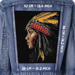 May include: A denim jacket with a large rectangular patch. The patch features a Native American woman in profile, wearing a headdress with yellow and red feathers. The patch is 32 cm wide, 36 cm tall, and 26 cm tall.