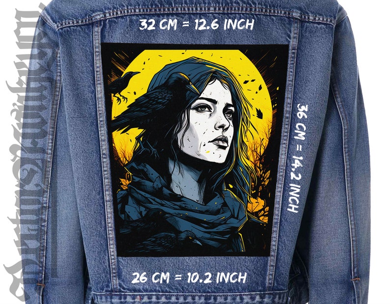 May include: A denim jacket with a black and yellow patch featuring a woman with long dark hair and a raven. The patch has the text "32 CM = 12.6 INCH", "36 CM = 14.2 INCH", and "26 CM = 10.2 INCH" printed on it.