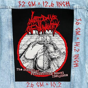 May include: A light blue denim jacket with a large black patch. The patch features a graphic illustration in red and white, with the text "LAST DAYS OF HUMANITY" and "The StEnch of Flatulating Bowel Incisions". The patch measures 32 cm by 36 cm.