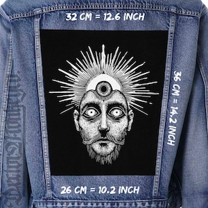 May include: A black and white illustration of a face with a third eye on a denim jacket. The face has a beard and mustache. The jacket has measurements in inches and centimeters.