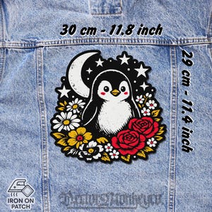 Peut inclure: Écusson thermocollant avec un dessin de pingouin de dessin animé, croissant de lune et étoiles. Le pingouin est entouré de fleurs et de roses. Le patch mesure 30 cm sur 29 cm.