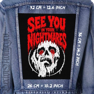 May include: A blue denim jacket featuring a large rectangular black patch on the back. The patch displays a white skull with red eyes and a hand, with the red text SEE YOU IN YOUR NIGHTMARES. Dimensions are 12.6 inches wide by 14.2 inches high.