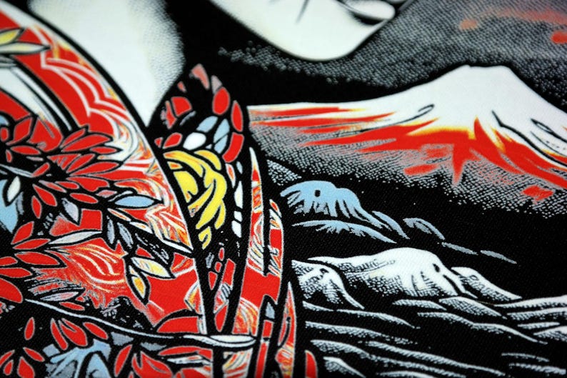 May include: A black and red patterned fabric with a design of a mountain range and a floral motif. The fabric has a textured surface and a graphic print.