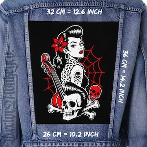 May include: A blue denim jacket featuring a large rectangular back patch with a black background. The graphic depicts a person with a red flower in their hair, a leopard print top, a double bass, a skull, and a spiderweb. Dimensions are 12.6 inches by 14.2 inches.