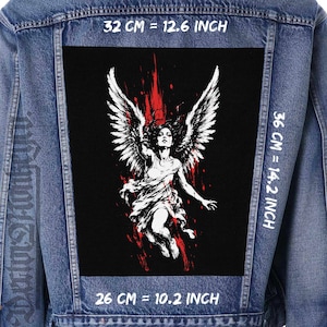 May include: A black fabric patch featuring a white illustration of a winged figure surrounded by red paint splatters. The patch is displayed on a blue denim jacket. Text on the image indicates dimensions of 32 cm by 36 cm, or 12.6 inches by 14.2 inches.