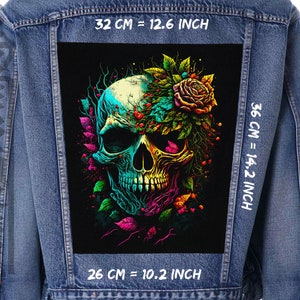 May include: A denim jacket with a colorful skull and floral design patch on the back. The patch measures 12.6 inches wide by 14.2 inches tall. The text "32 CM = 12.6 INCH", "36 CM = 14.2 INCH", and "26 CM = 10.2 INCH" is printed on the jacket.