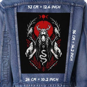 May include: A denim jacket with a large black patch featuring a detailed illustration. The patch includes a central figure with antlers, a red sun, ravens, wolves, and a serpent. The patch measures 12.6 inches by 14.2 inches and 10.2 inches.