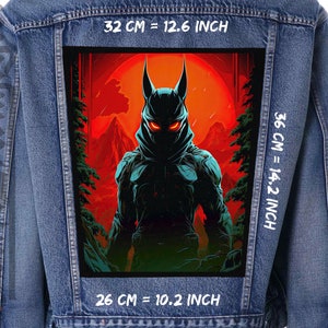 May include: A denim jacket with a large rectangular patch. The patch depicts a figure in a horned mask with glowing red eyes, set against a red sky and mountain backdrop. The patch measures 32 cm wide and 36 cm tall.