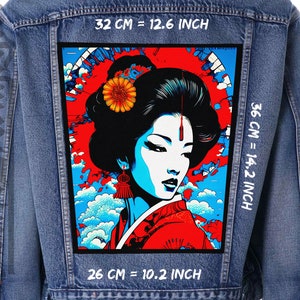May include: A denim jacket with a large, colorful patch on the back. The patch features a stylized image of a woman with a red and blue background. The text "32 CM = 12.6 INCH", "36 CM = 14.2 INCH", and "26 CM = 10.2 INCH" is printed on the jacket.