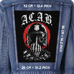May include: A black rectangular fabric patch featuring a white graphic of a skeleton hand giving the middle finger, wearing a cracked police helmet against a red circle. The text A.C.A.B. is printed above. Dimensions are 32 cm by 36 cm by 26 cm.