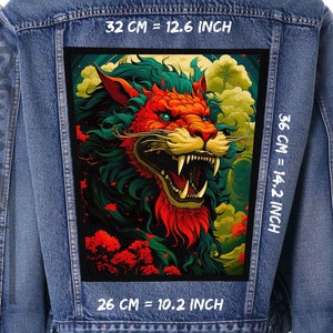 May include: A denim jacket with a colourful embroidered patch of a roaring lion with green, red and yellow details. The patch is 32 cm wide, 36 cm tall and 26 cm deep.