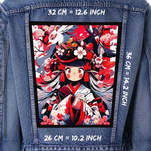 May include: A denim jacket with a colourful anime-style patch featuring a female character with long, flowing hair, a red and white outfit, and a white fox mask. The patch is surrounded by pink cherry blossoms and has the text "32 CM = 12.6 INCH", "36 CM = 14.2 INCH", and "26 CM = 10.2 INCH" printed on the jacket.