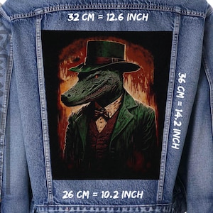 May include: A denim jacket with a large rectangular patch. The patch features a stylish alligator wearing a green top hat and suit. The patch measures 32 cm wide by 36 cm tall. The alligator has a bow tie and a serious expression.