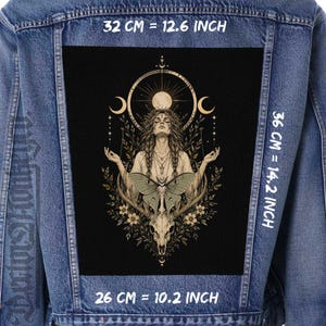Può includere: Una giacca di jeans blu con una grande toppa rettangolare sul retro su sfondo nero. La toppa mostra un'illustrazione centrale di una persona con una falena, un teschio e simboli celesti. Le dimensioni sono 32 cm per 36 cm.